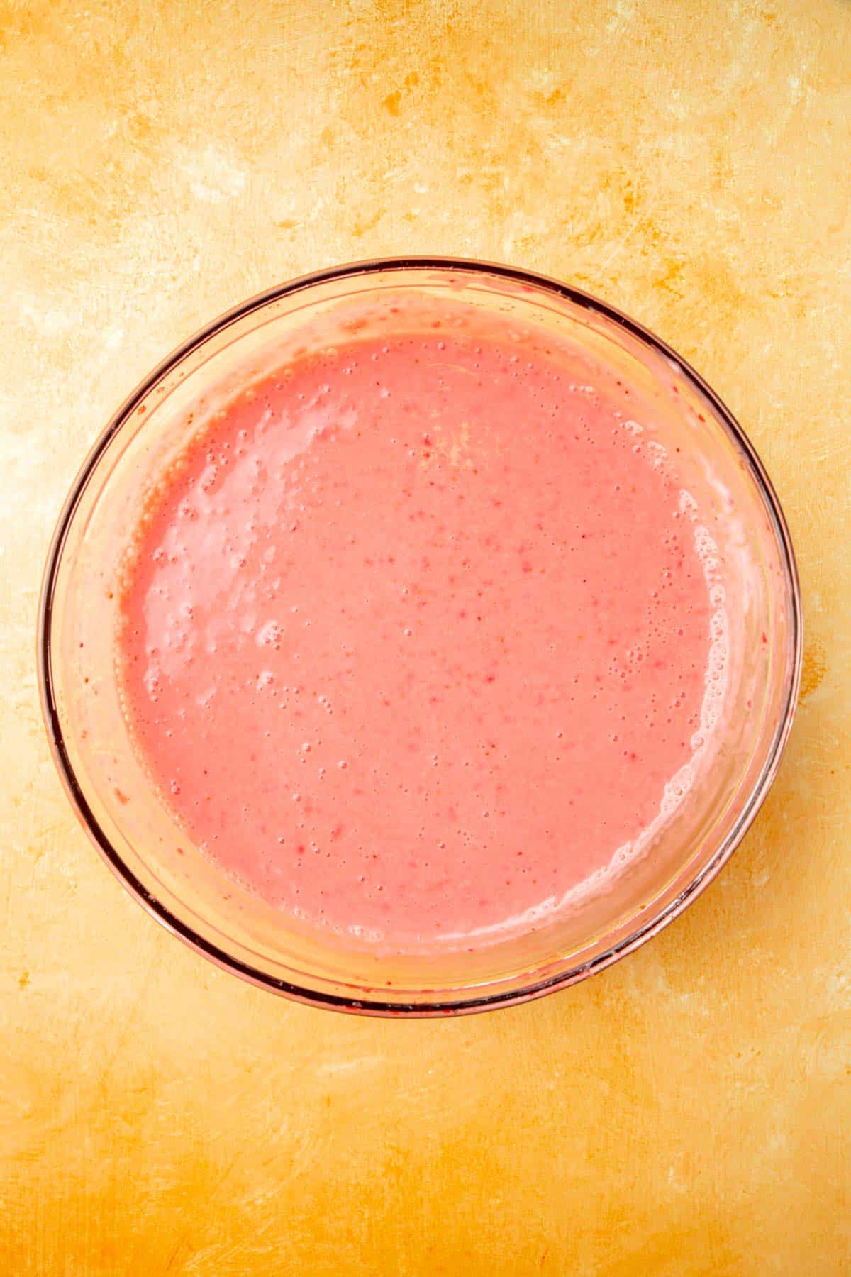 A bowl of strawberry frozen yogurt mixture before churning.