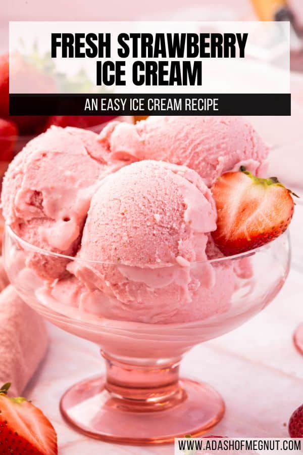 A close up of scoops of strawberry ice cream in a pink bowl with fresh strawberry halves on top.