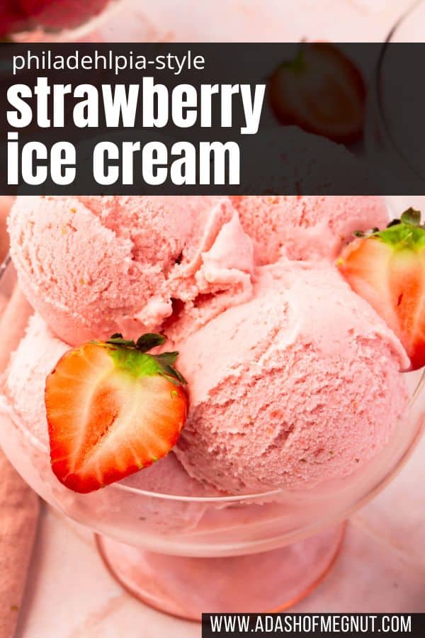 A closeup of scoops of strawberry ice cream in a bowl with strawberry halves on top.