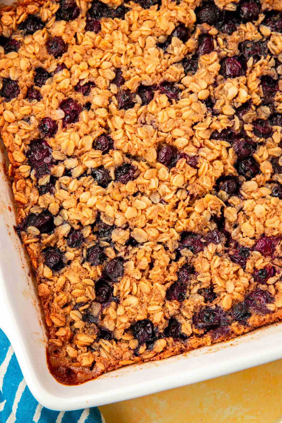 A closeup of a baking dish of gluten-free blueberry baked oatmeal in it.