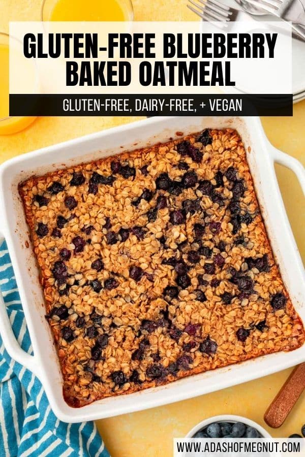 A square baking dish filled with gluten-free blueberry baked oatmeal on a yellow table with glasses of orange juice.