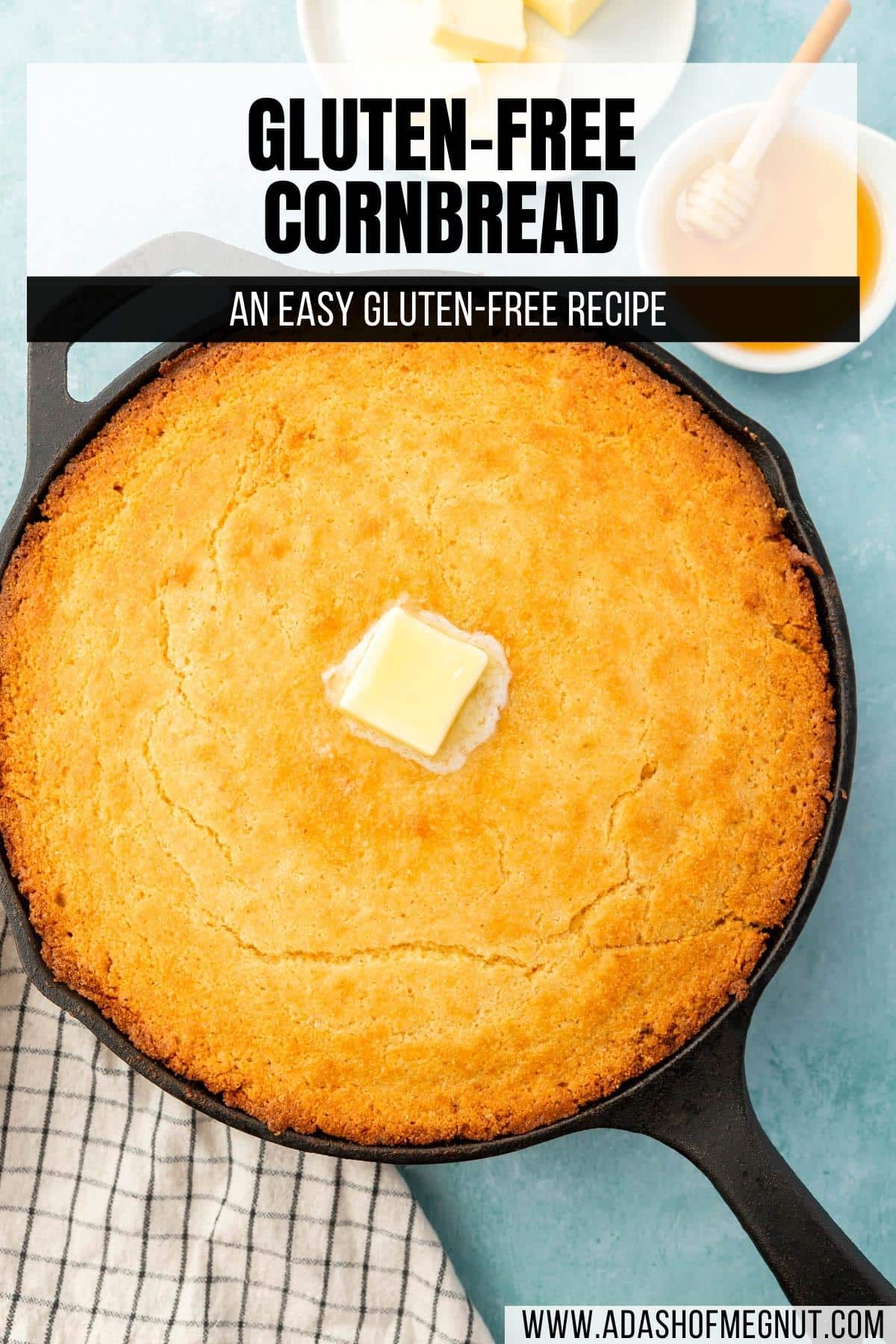 A cast iron skillet filled with gluten-free cornbread with a pat of melted butter on top with a text overlay over the image.