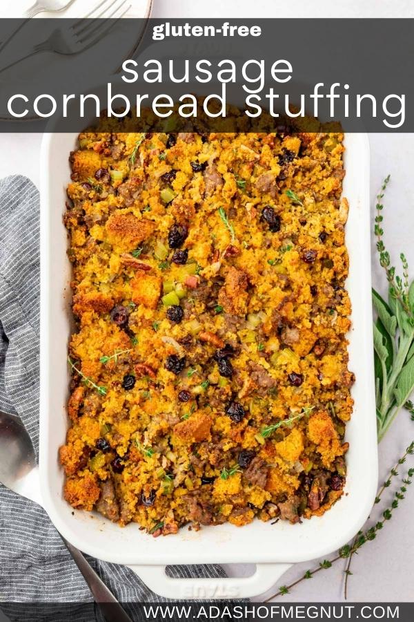 A rectangular baking dish of gluten-free cornbread stuffing with fresh thyme and fresh sage off to the side.
