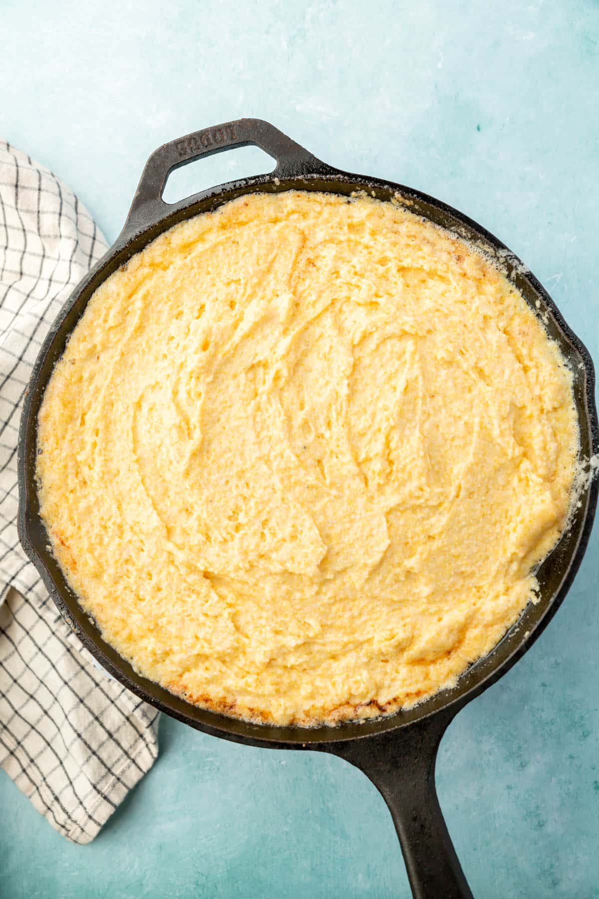 A cast iron skillet filled with gluten-free cornbread batter before baking.