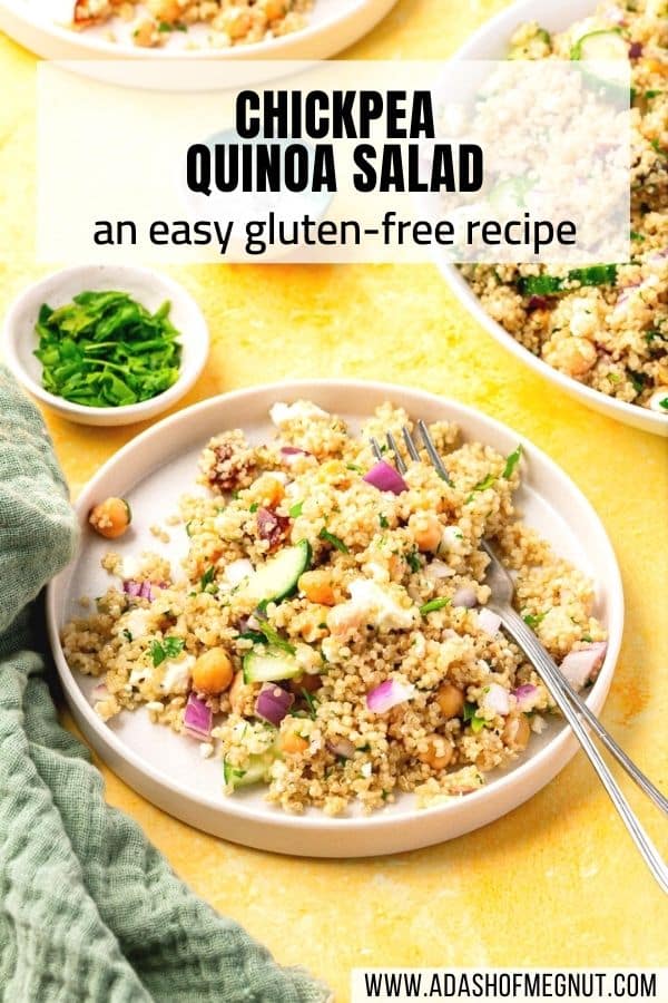 A salad plate with a cold quinoa chickpea salad with a fork digging into it next to a bowl of parsley and a bowl of salt.