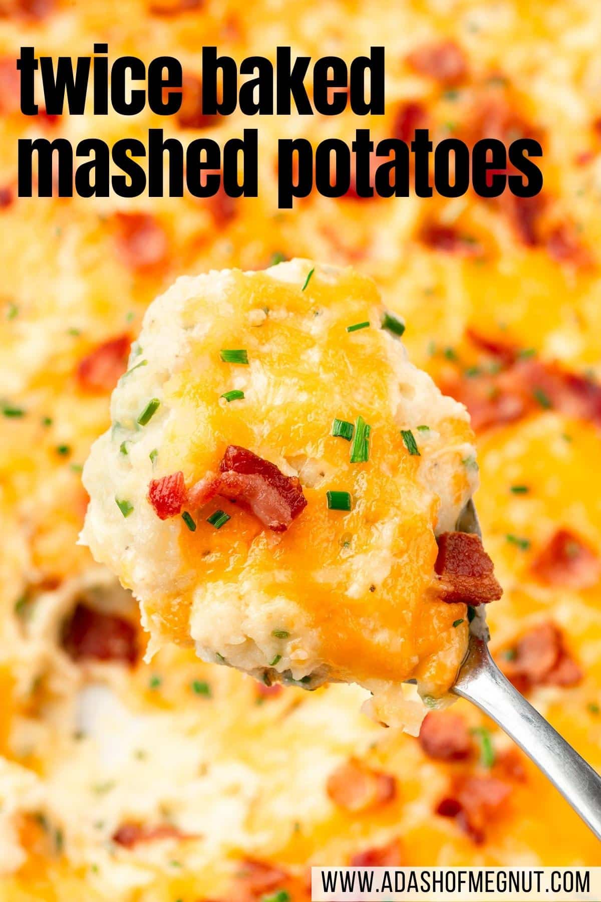 A large spoonful of twice baked mashed potatoes over a larger casserole dish.