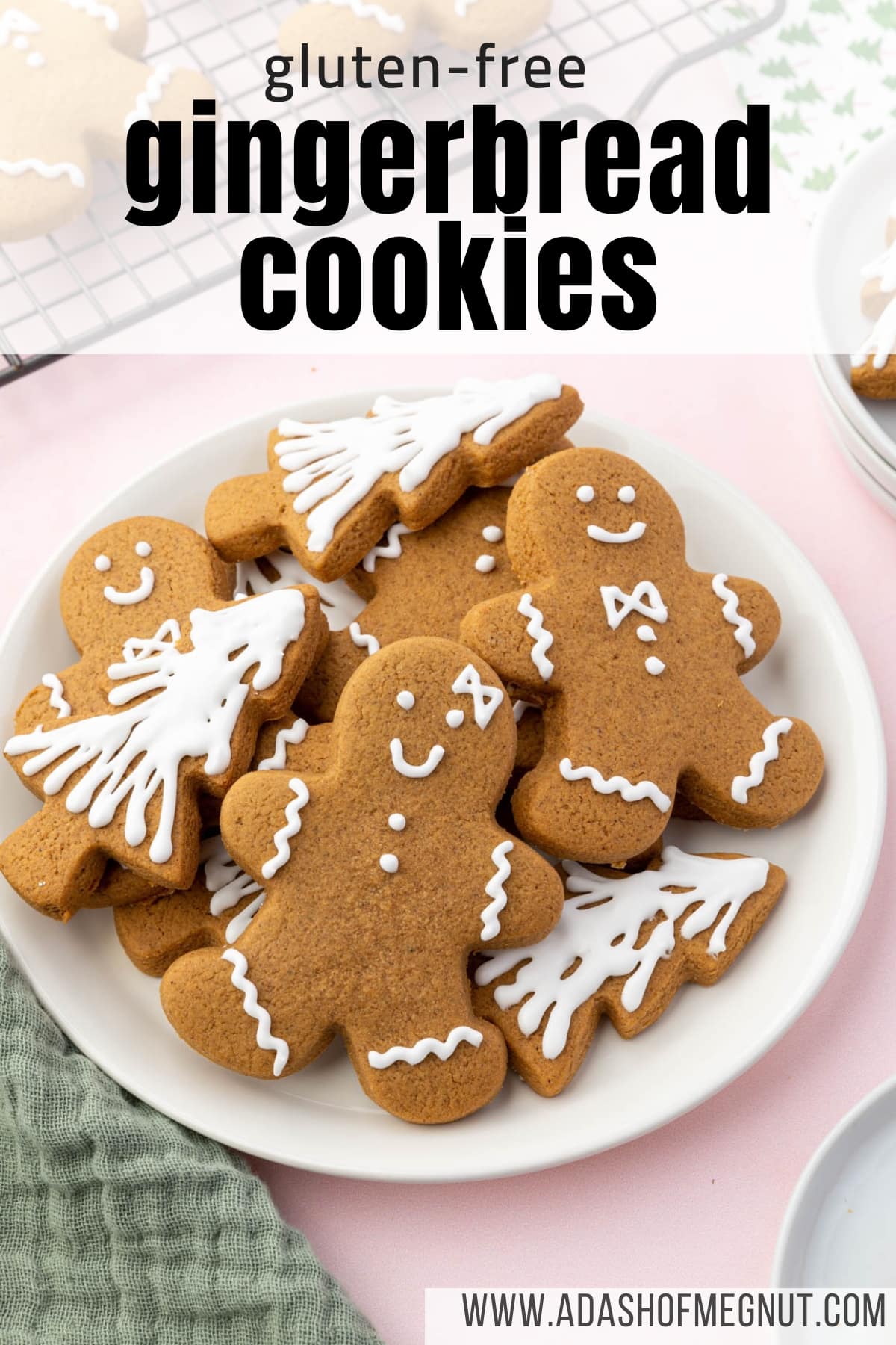 A plate of gluten-free gingerbread cookies shaped like Christmas trees and gingerbread men decorated with royal icing.