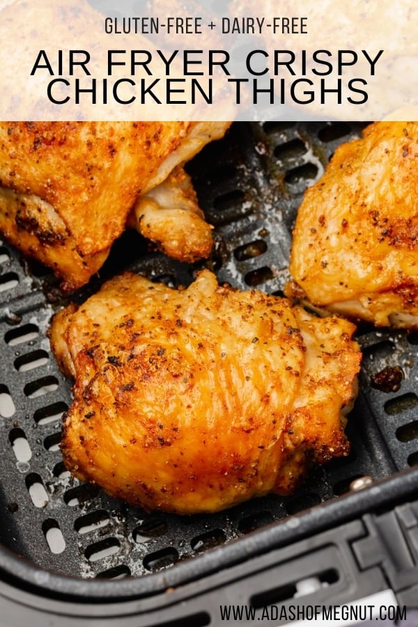 A closeup of crispy bone-in chicken thighs with skin in the air fryer basket.