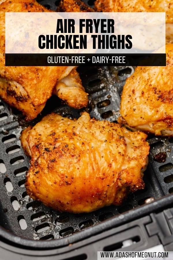 A closeup of crispy bone-in chicken thighs with skin in the air fryer basket.