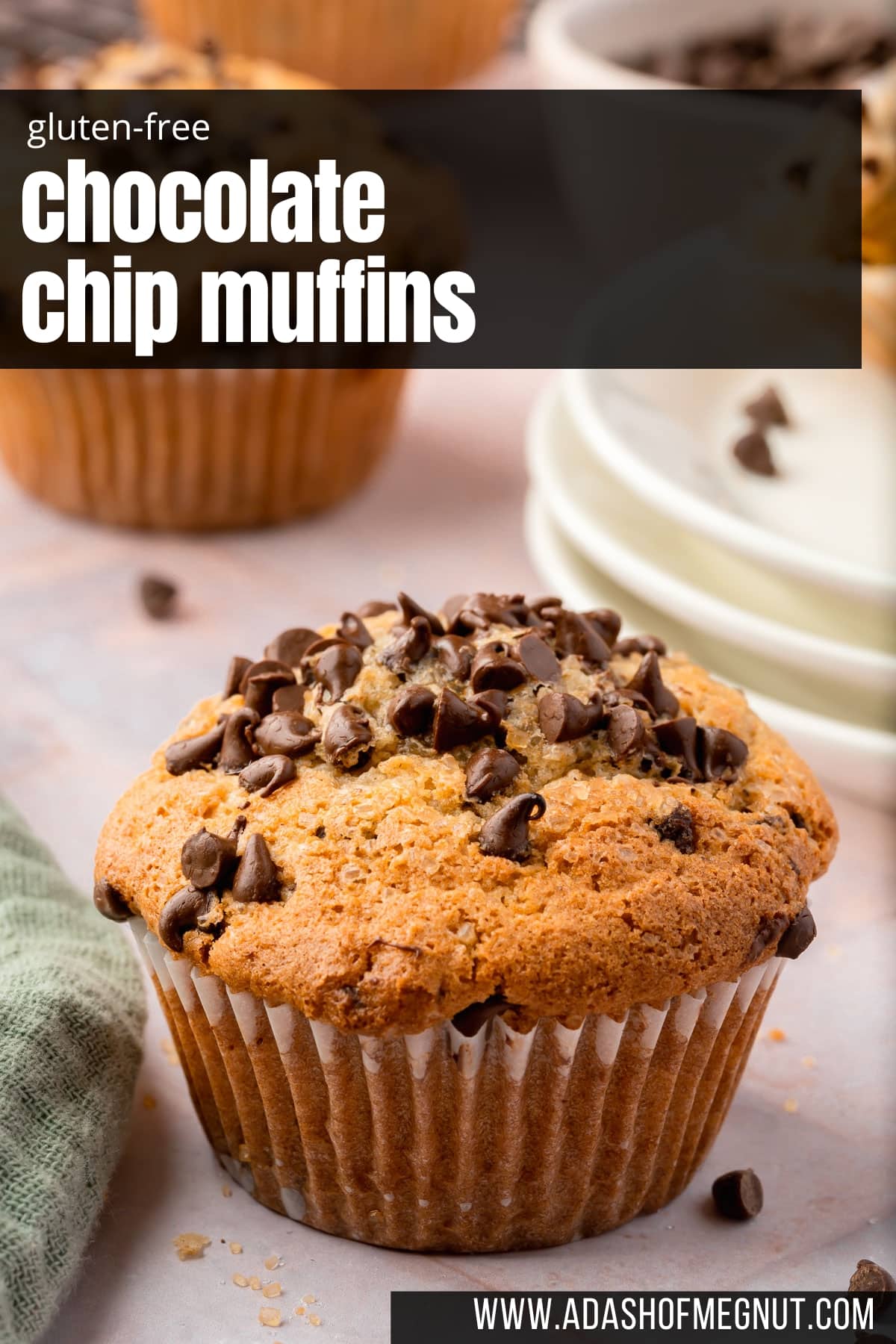 A single gluten-free mini chocolate chip muffin with a stack of mini dessert plates behind it.