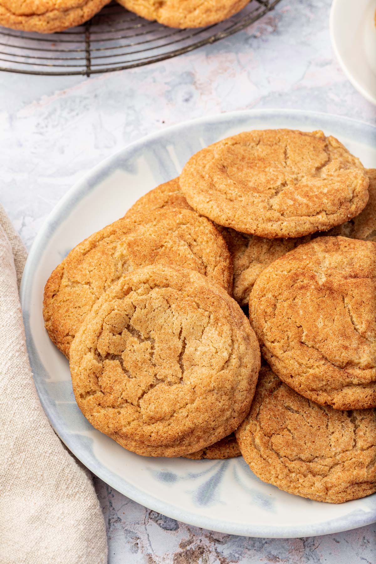 A pile of gluten-free snickerdoodles on a blue plate.