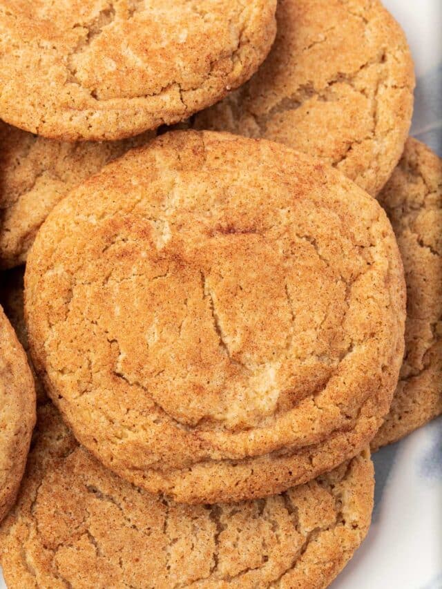 A closeup of a plate of gluten-free snickerdoodles on it.