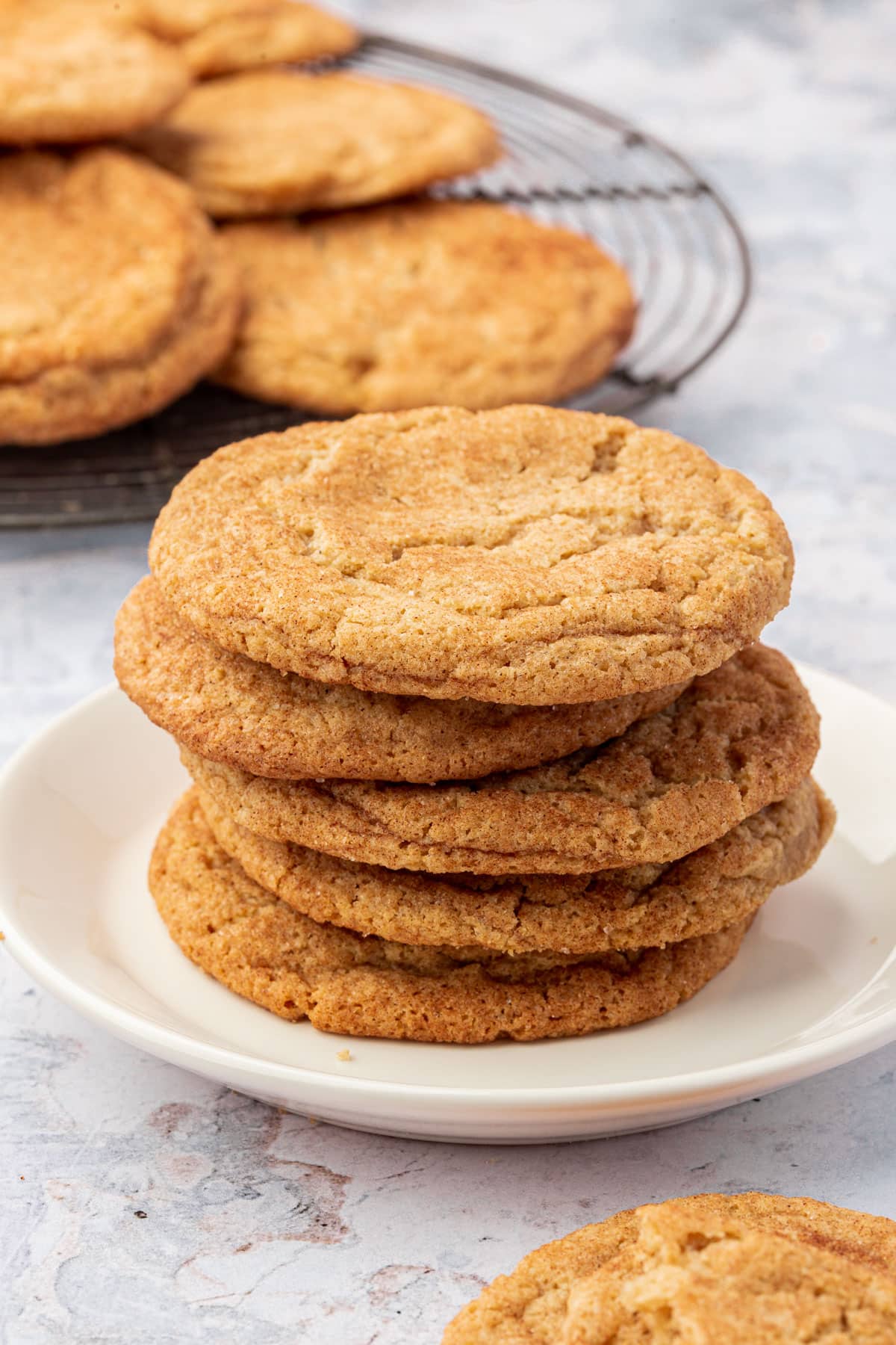 A stack of gluten-free snickerdoodle cookies on a small dessert plate.