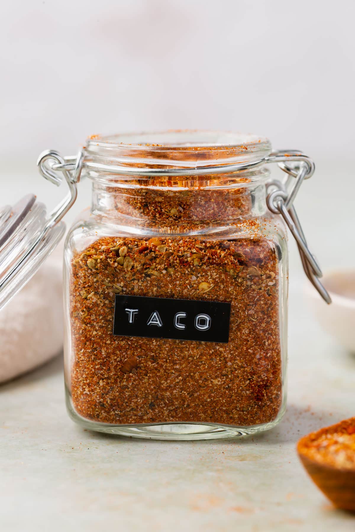 Gluten-free taco seasoning in a glass jar with a black and white label that says "taco" on it.