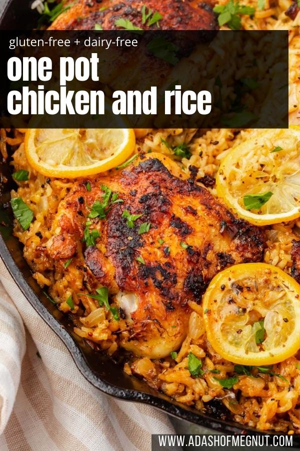 A close up of roasted chicken thighs on top of a bed of seasoned white rice and topped with charred lemon slices and fresh parsley in a cast iron skillet.