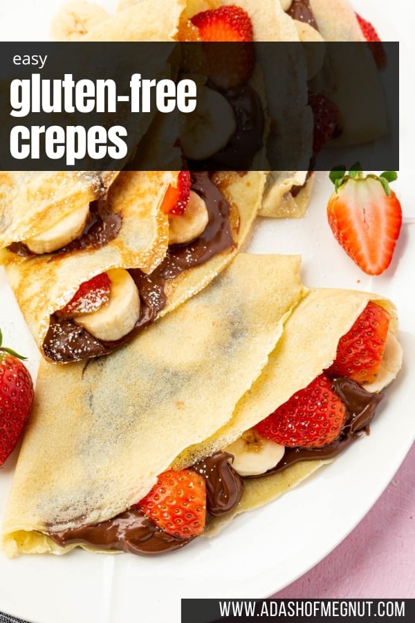 A closeup of two gluten-free crepes filled with nutella, sliced strawberries and bananas.