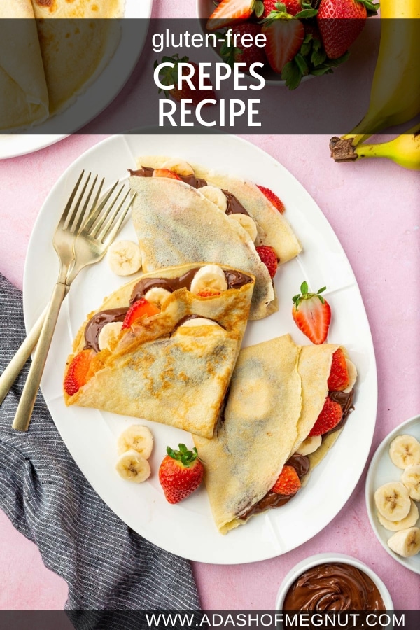 A platter with three gluten-free crepes filled with nutella, banana slices, and sliced strawberries with a few forks.