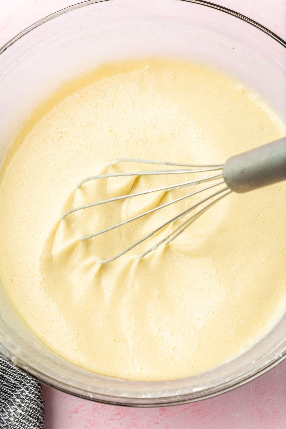 Gluten-free crepe batter being whisked in a large mixing bowl.