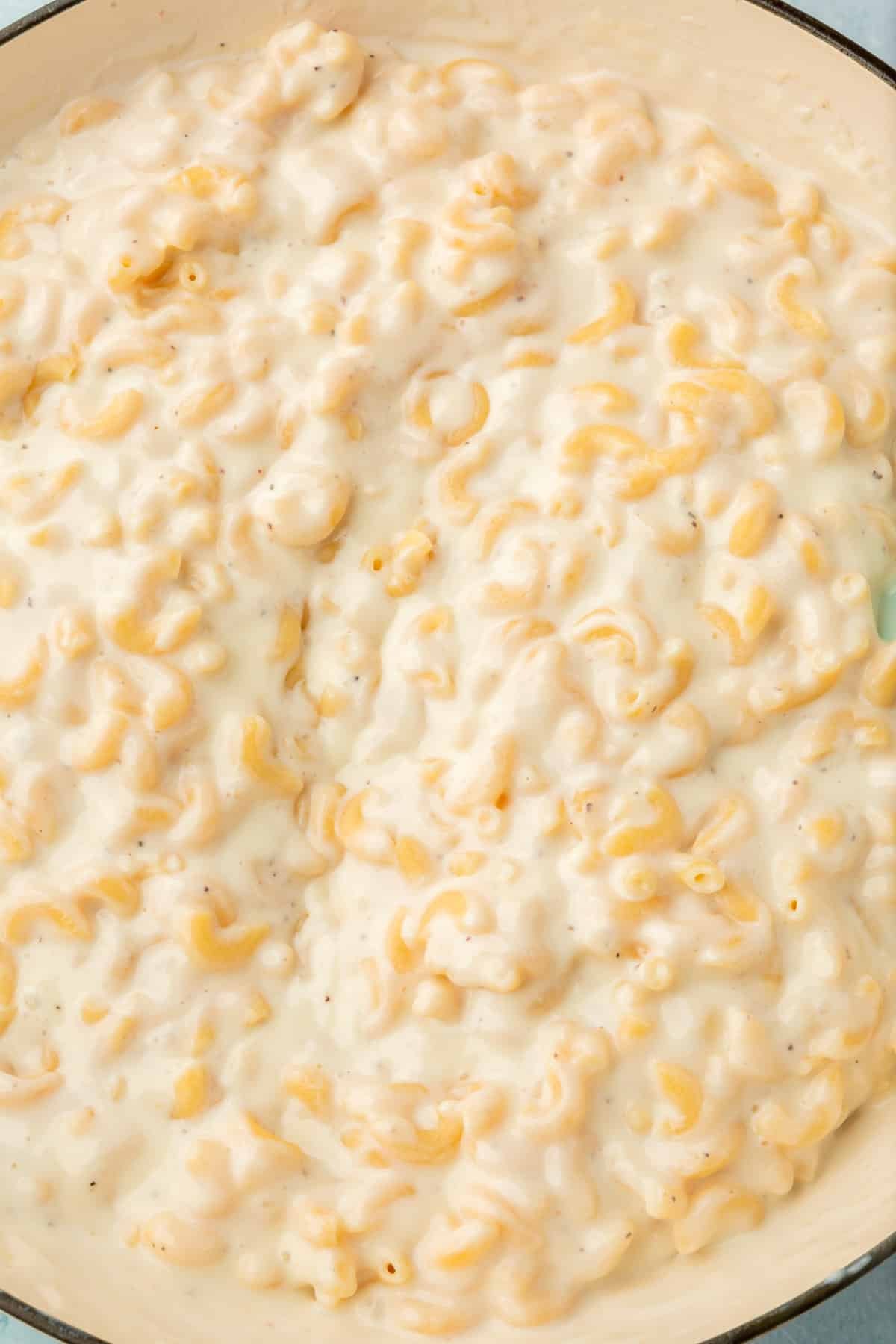 A closeup of mozzarella mac and cheese in a white skillet.