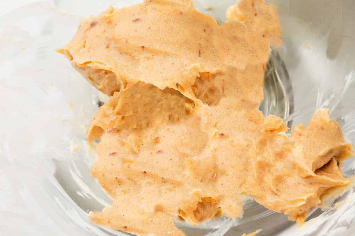 A glass mixing bowl with solidified browned butter in it.
