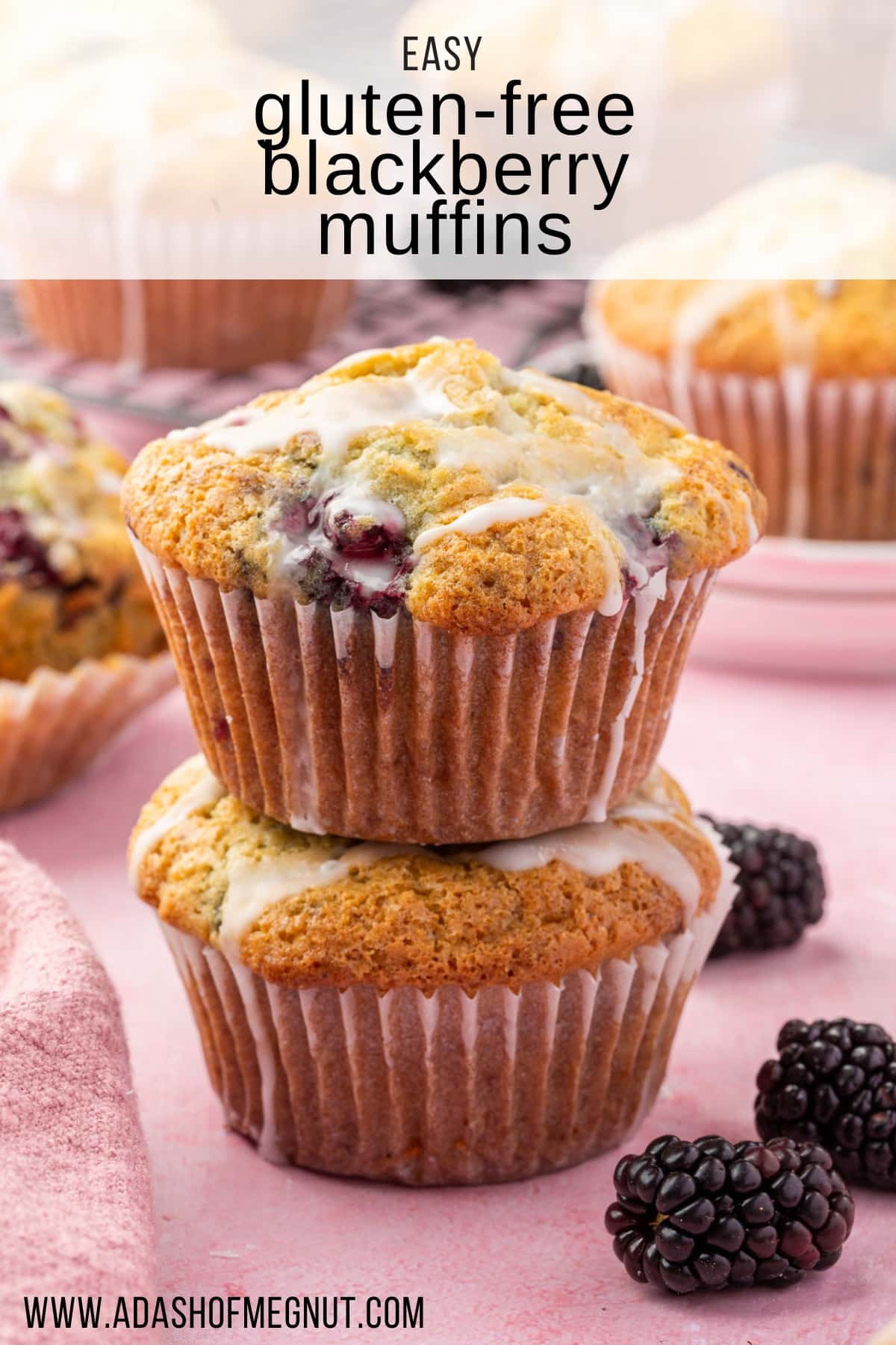 A stack of two gf blackberry muffins with fresh blackberries on the surface.