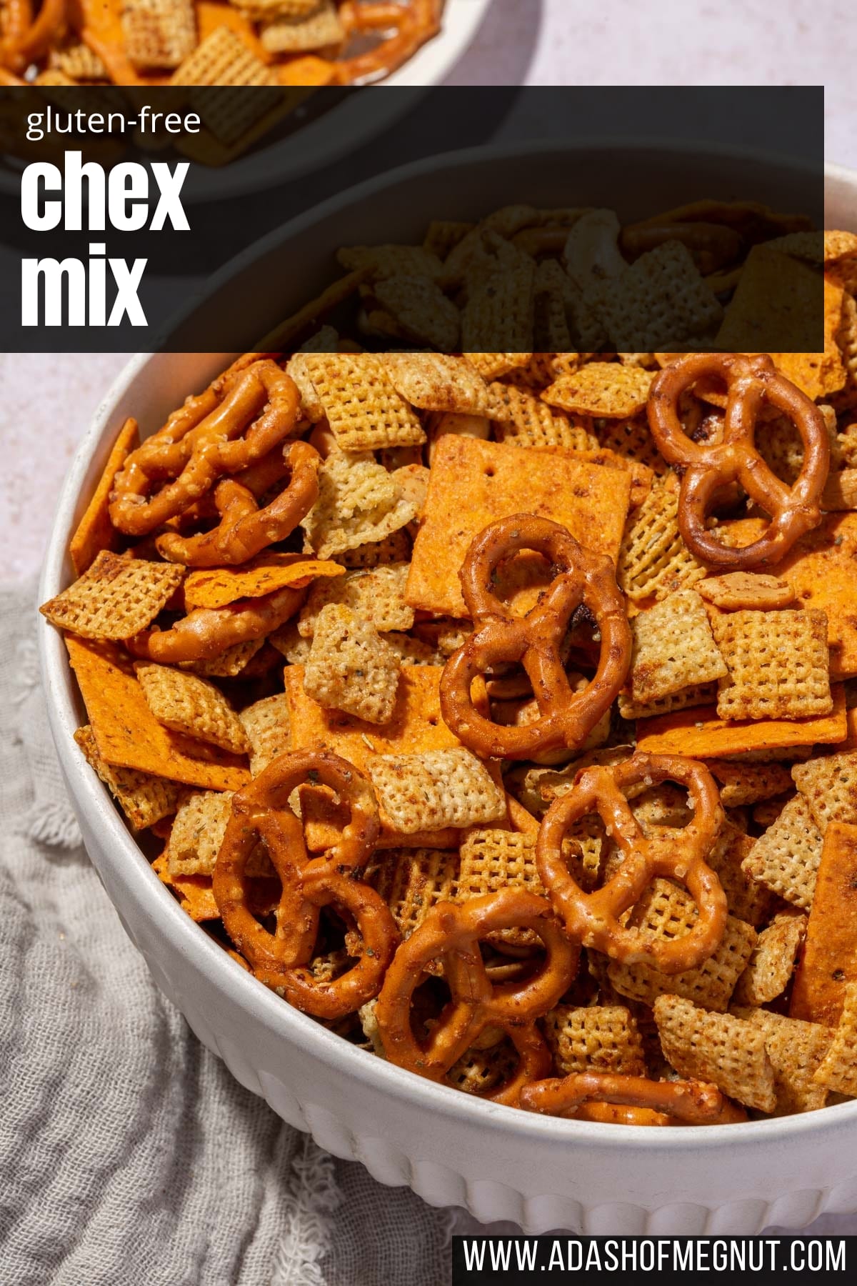 A closeup of a large serving bowl with chex mix in it.
