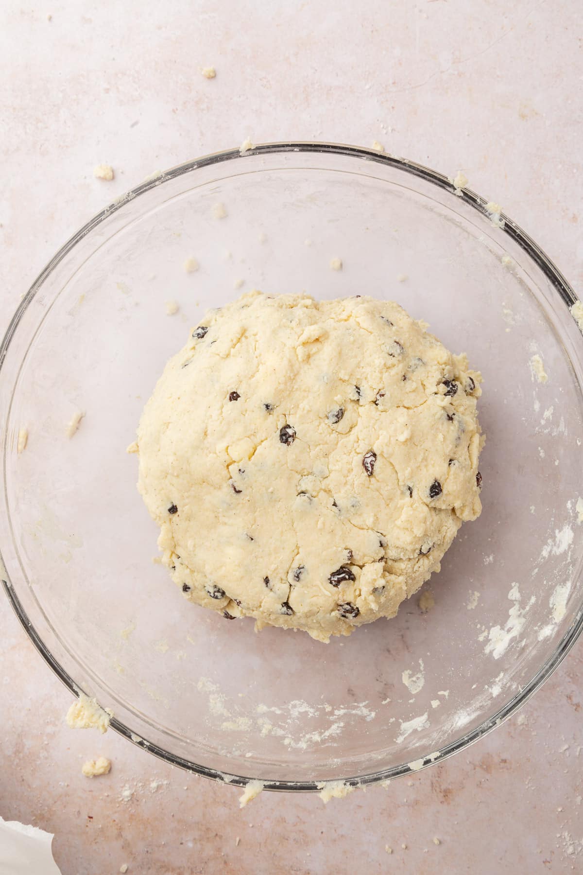 A glass mixing bowl with a disk of gluten-free Irish soda bread dough.