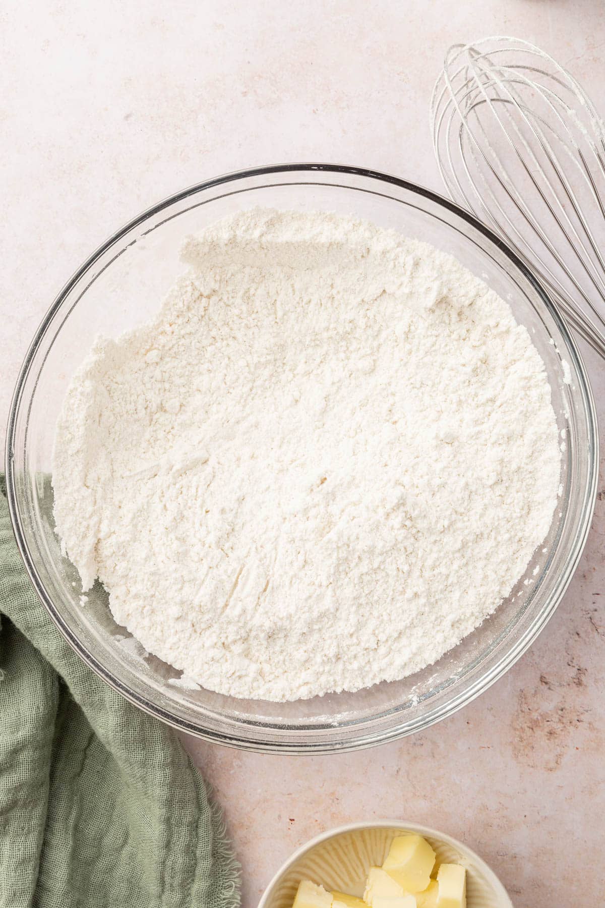 A glass mixing bowl with a gluten-free flour mixture in it.