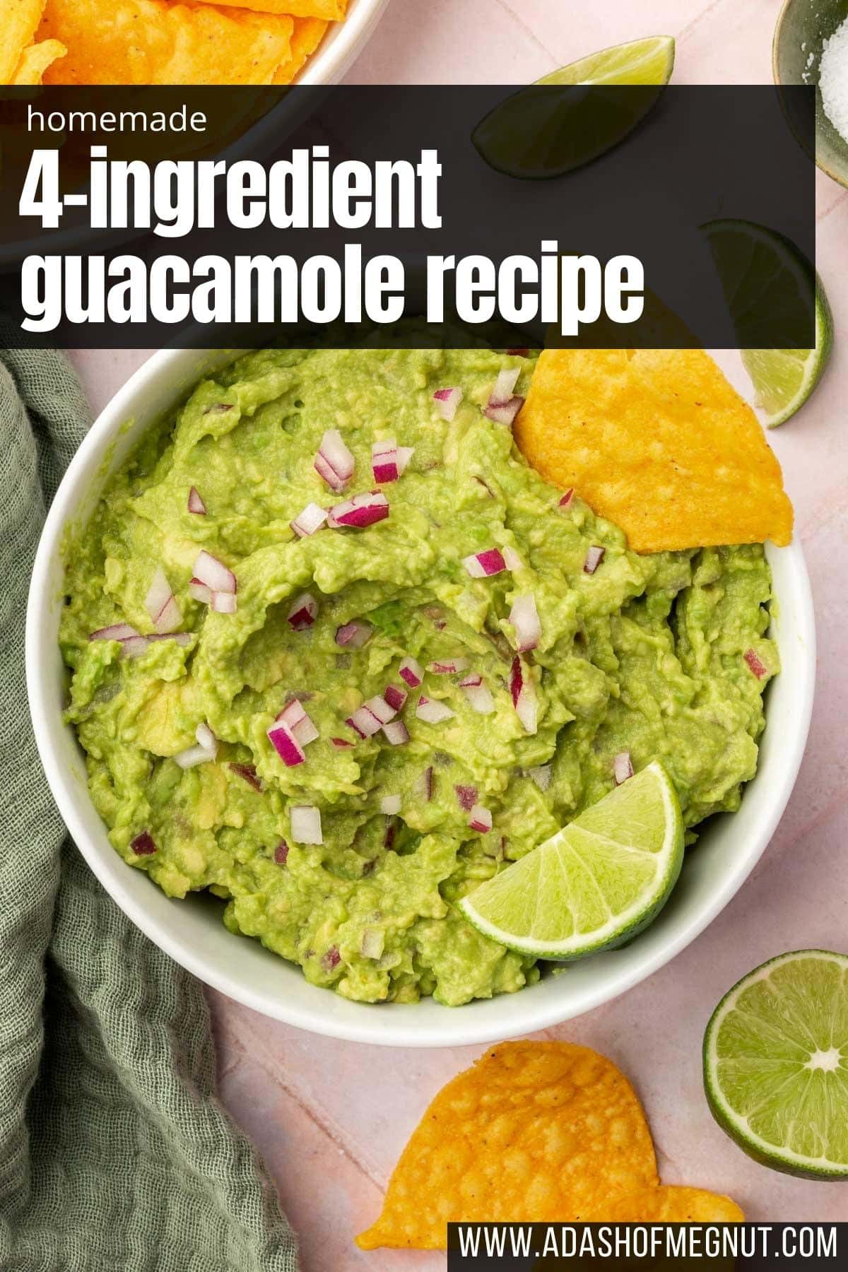 A bowl of 4-ingredient guacamole topped with finely diced red onion, tortilla chip and a lime wedge.