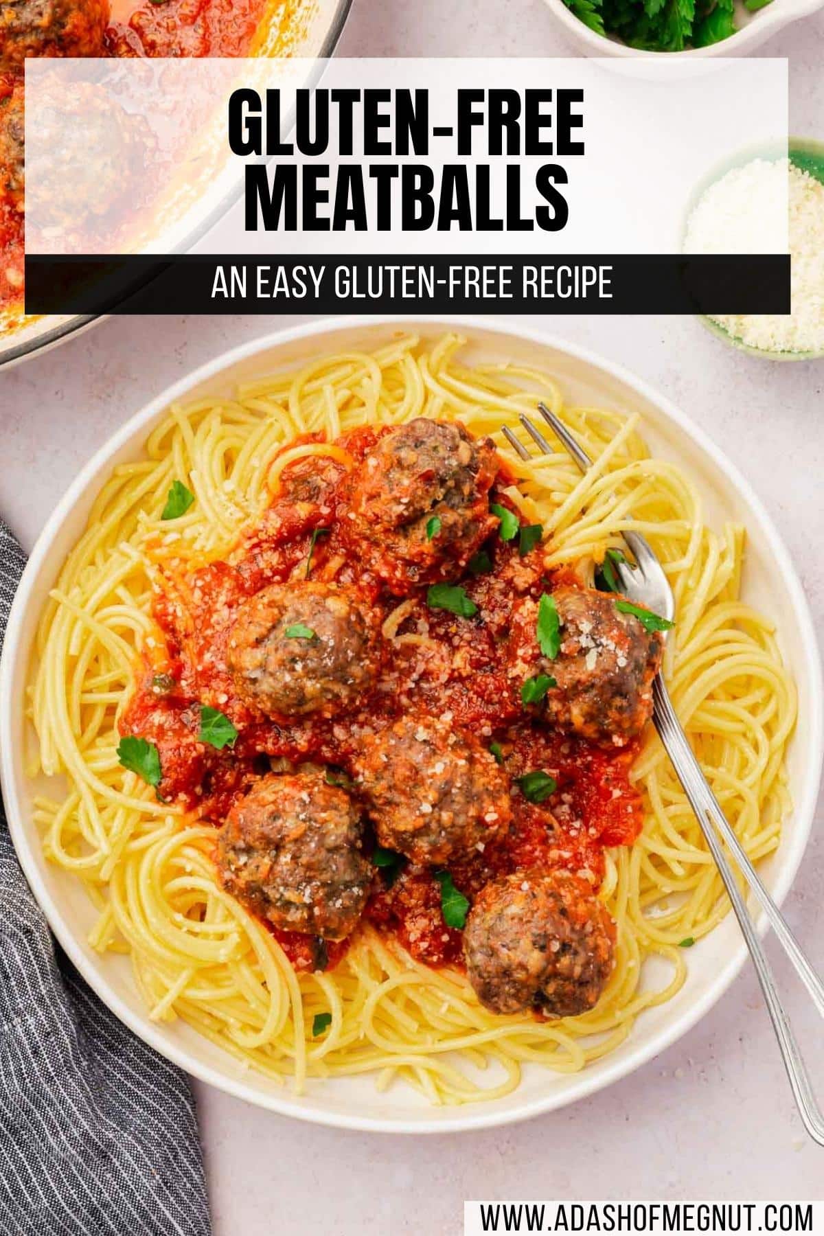 A bowl of gluten-free spaghetti topped with six beef meatballs with a fork in the bowl.