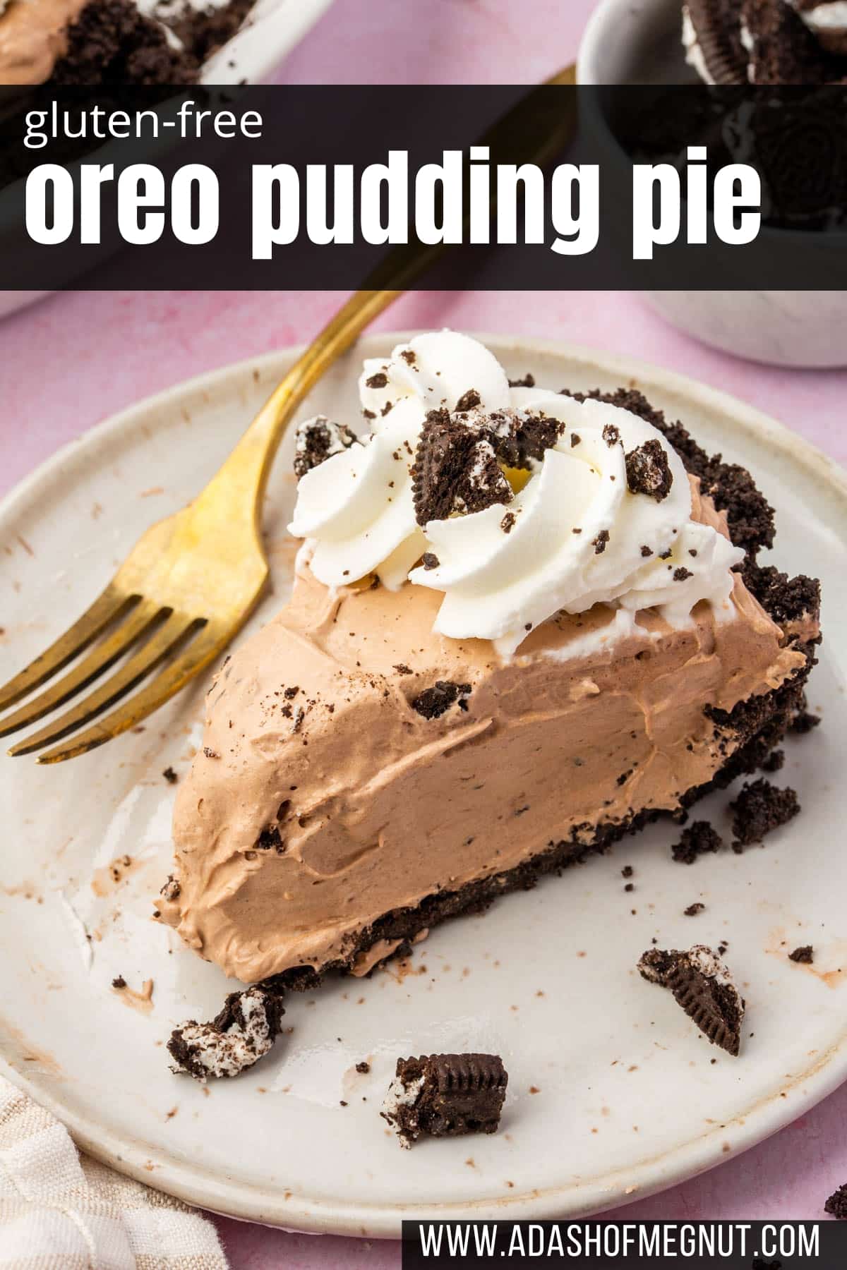 A slice of Oreo pudding pie with an Oreo crust on a dessert plate with a gold fork.