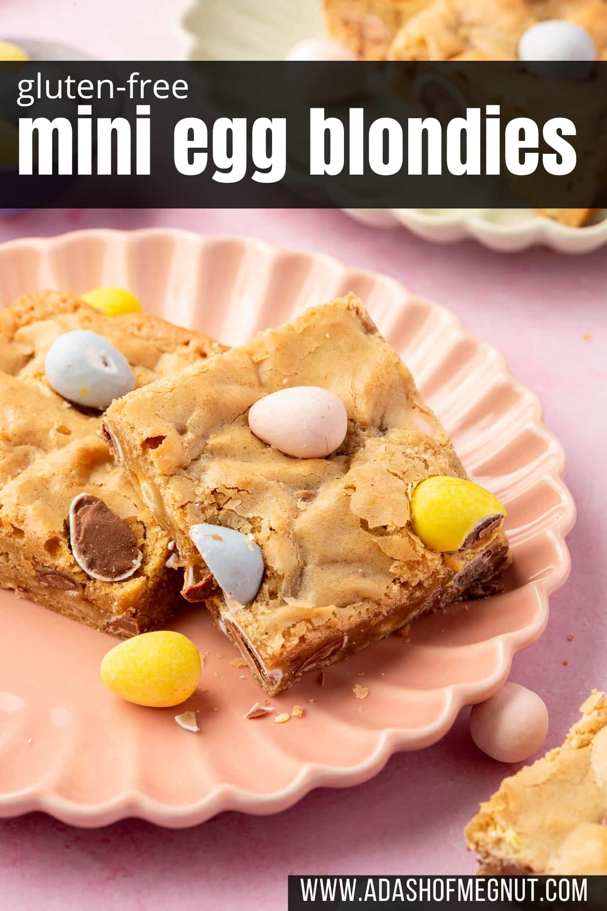 Two gluten-free blondies with mini cadbury eggs on a dessert plate.