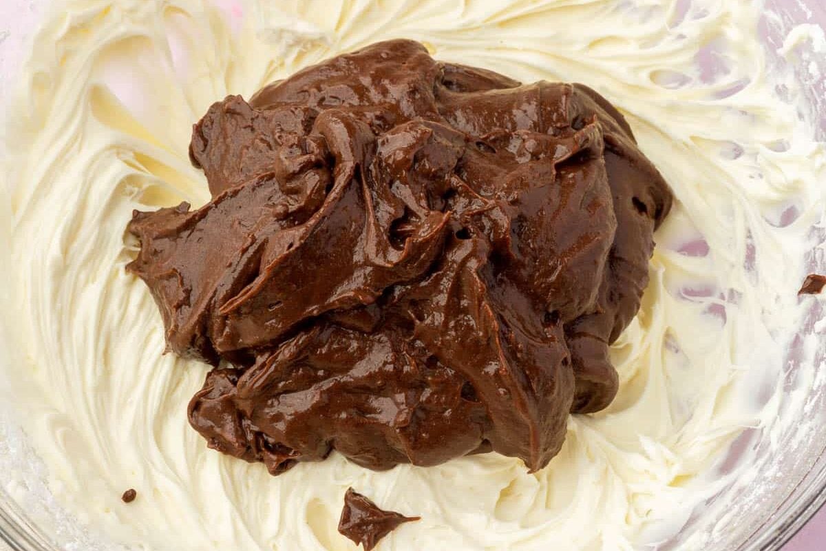 A cream cheese mixture topped with chocolate pudding.