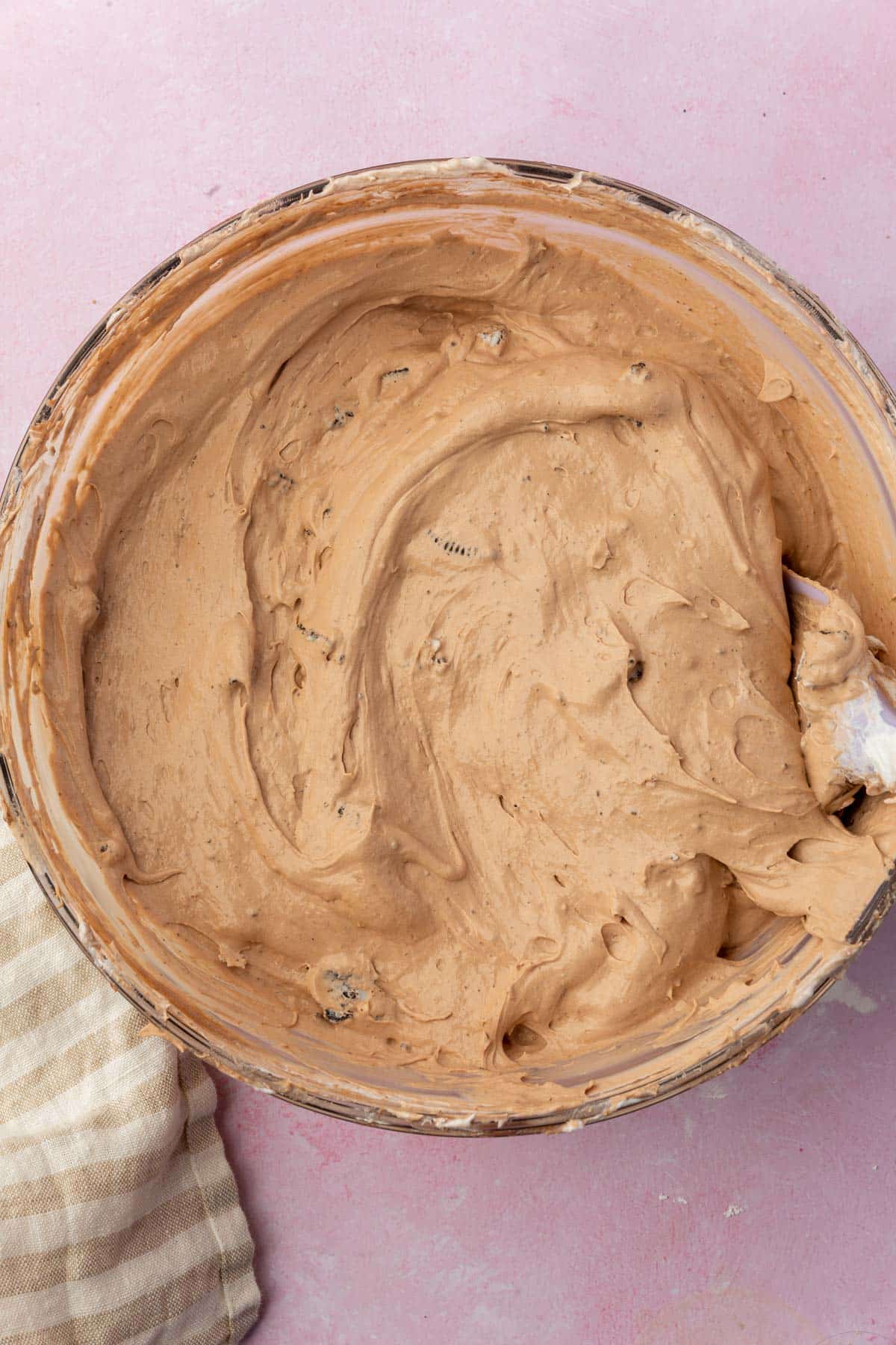 A closeup of a glass mixing bowl with a whipped chocolate pudding mixture.