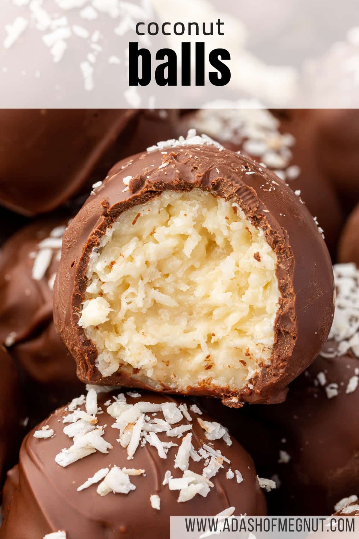 A single coconut truffle ball with a bite taken out of it so you can see the coconut inside.