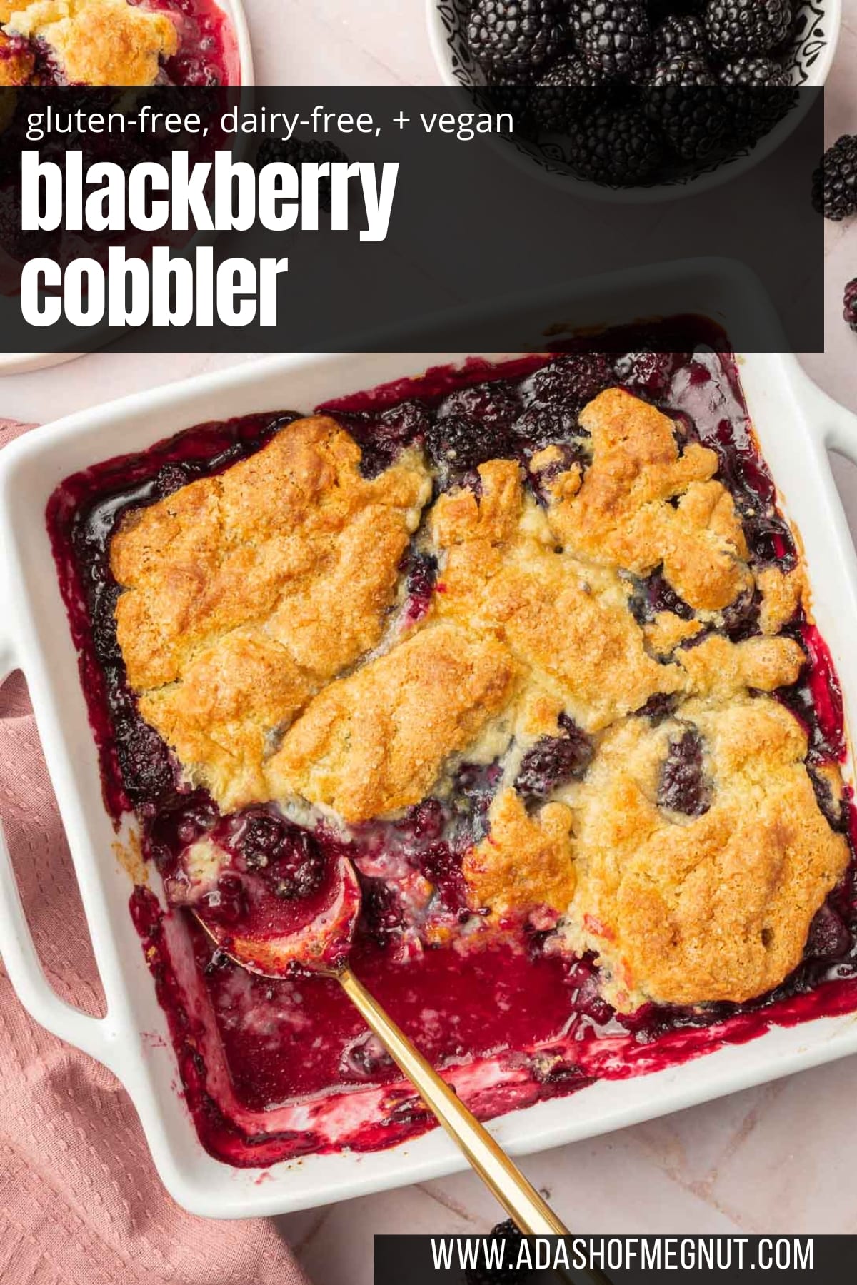 Gluten-free blackberry cobbler in a square baking dish with a spoon and a portion missing from the pan.