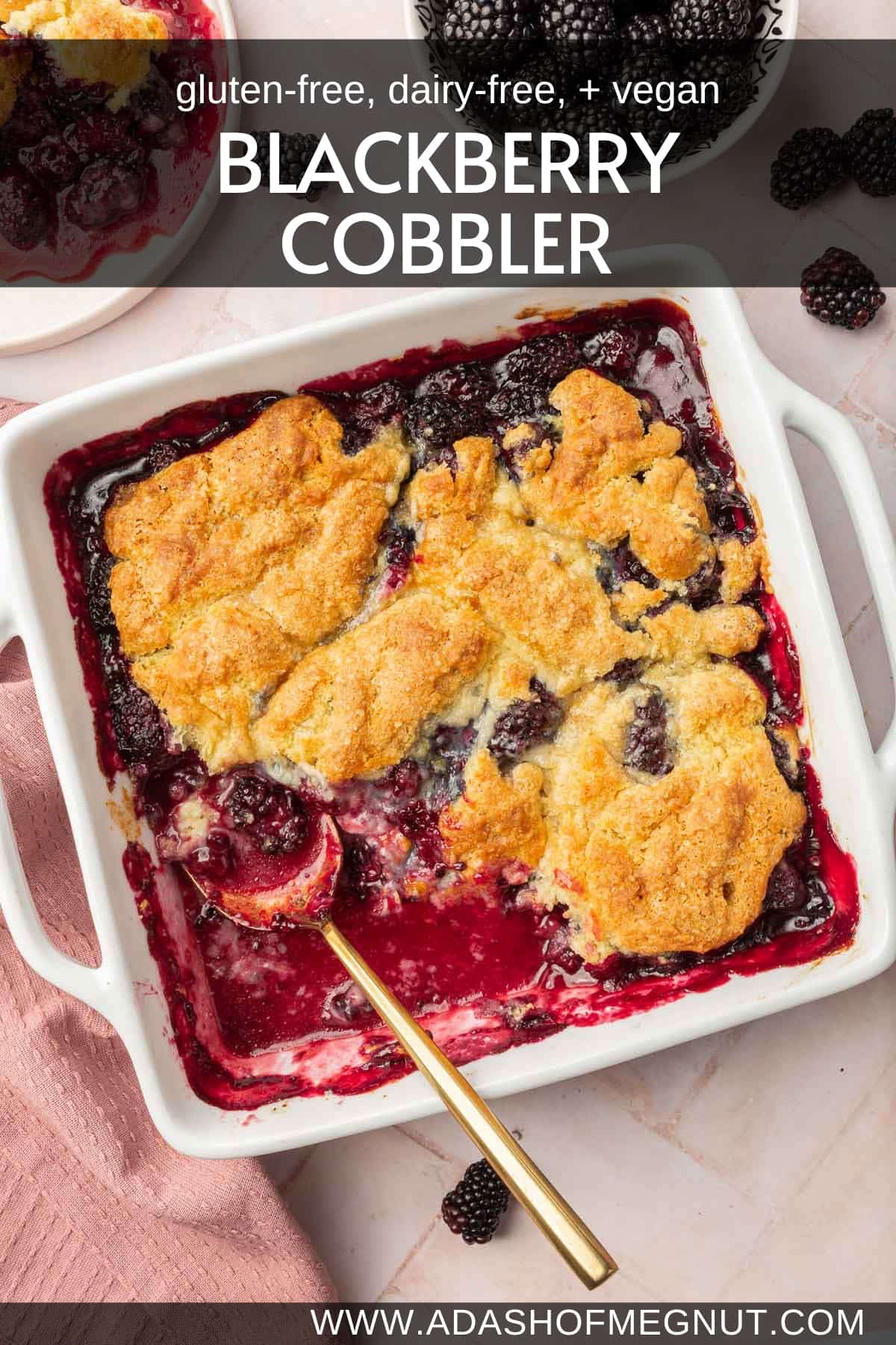 Gluten-free blackberry cobbler in a square baking dish with a spoon and a portion missing from the pan.