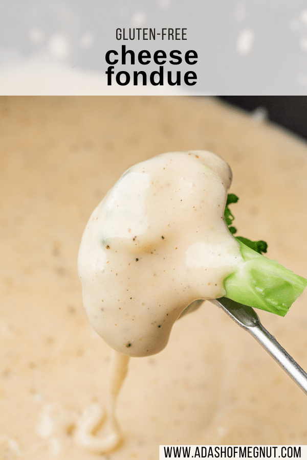 A fondue fork skewered piece of broccoli covered in gluten-free cheese fondue that is dripping into the fondue pot.