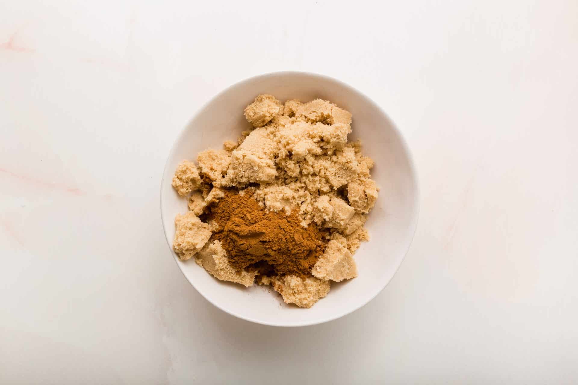 A small bowl of brown sugar and cinnamon before mixing together.