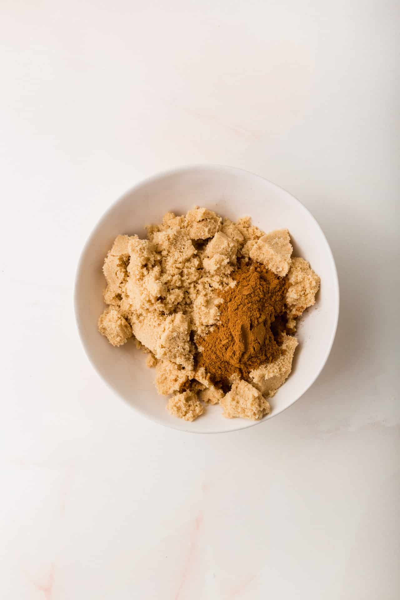 A small bowl of brown sugar and cinnamon before mixing together.