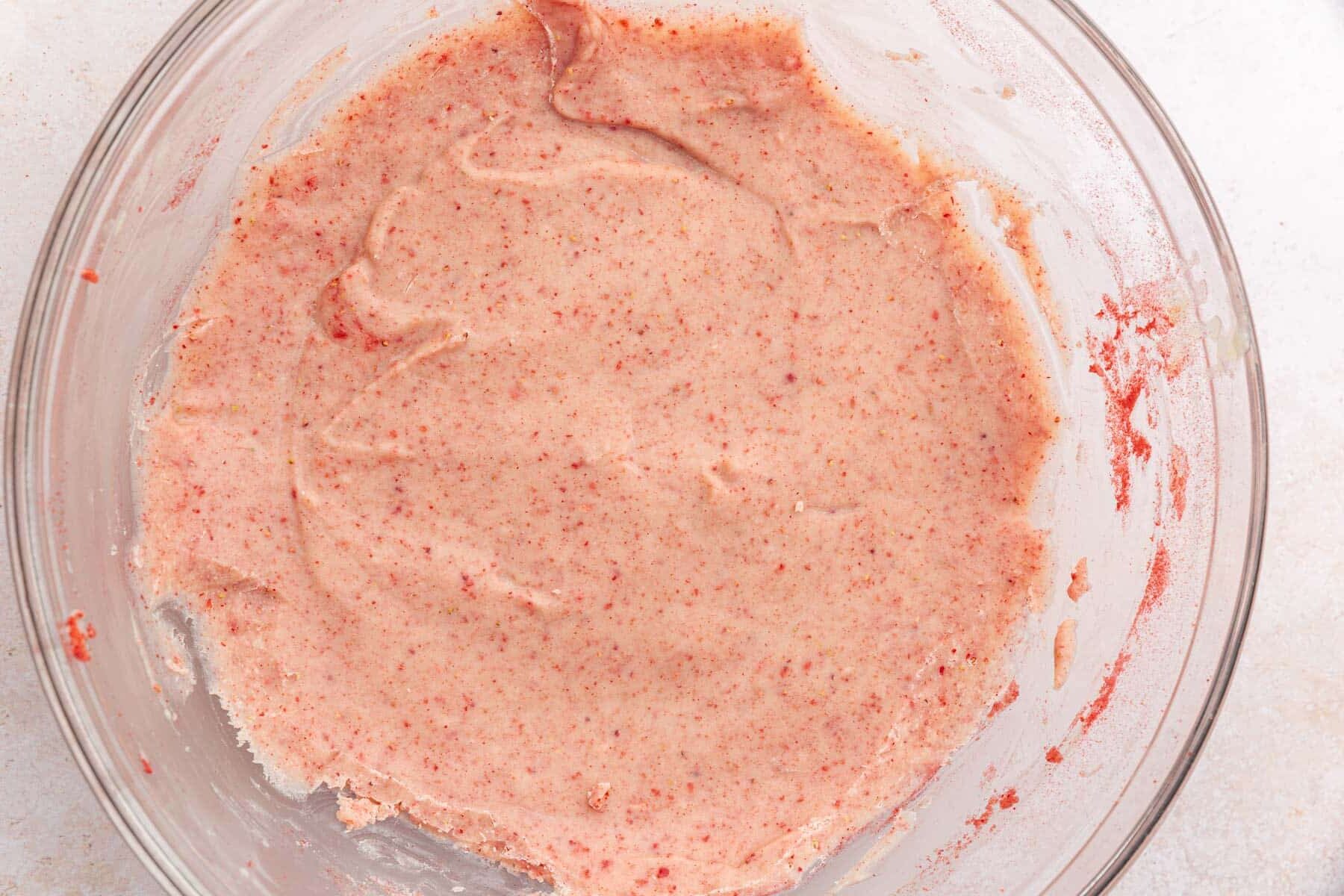 A glass mixing bowl with a strawberry white chocolate truffle mixture that has been chilled.