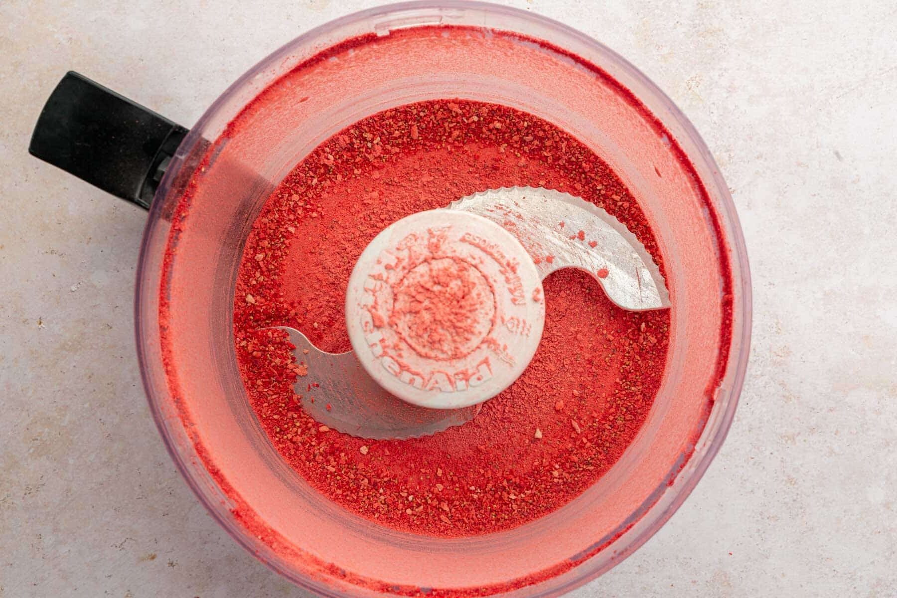 A food processor with freeze-dried strawberry powder in it.