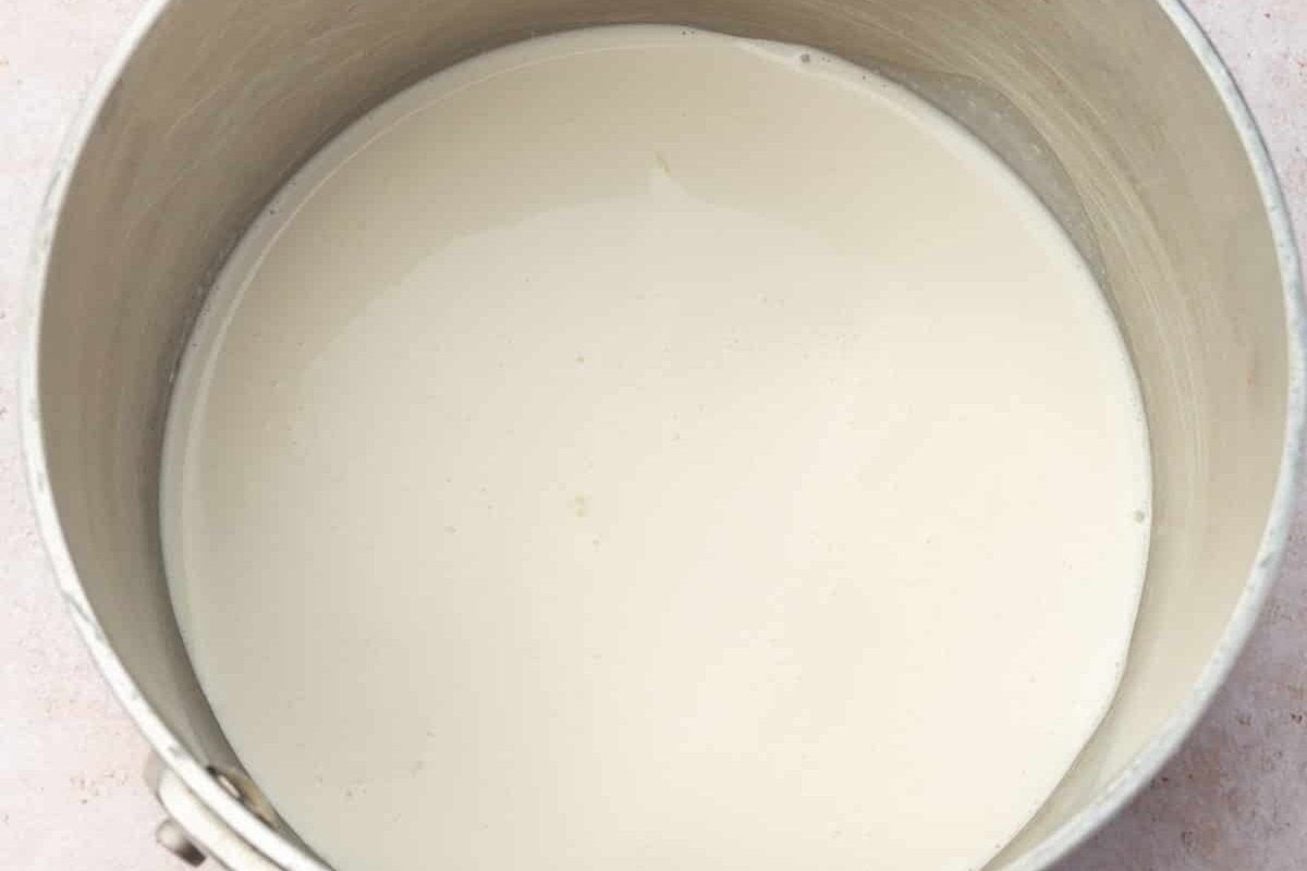 A saucepan with heavy cream in it.