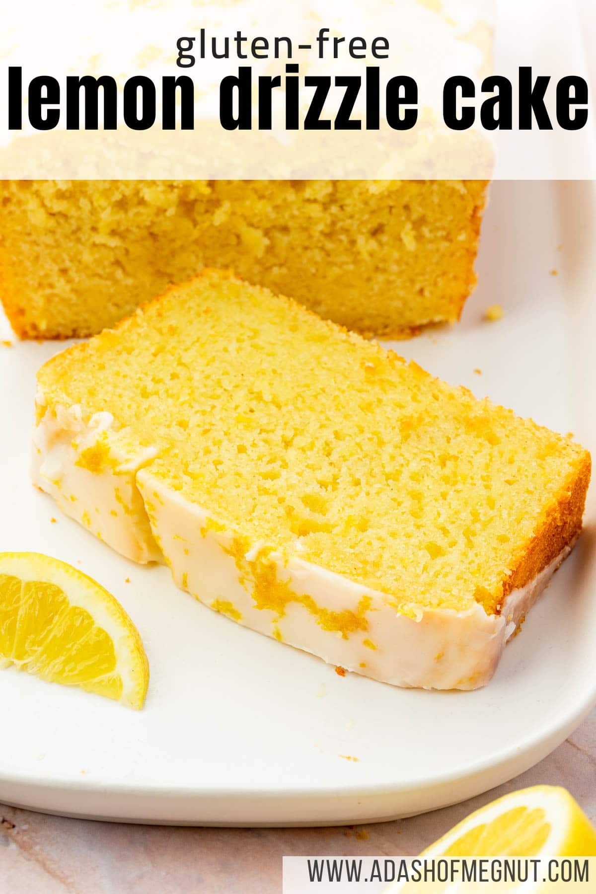 A single lemon drizzle cake slice on a white platter with lemon wedges surrounding it.