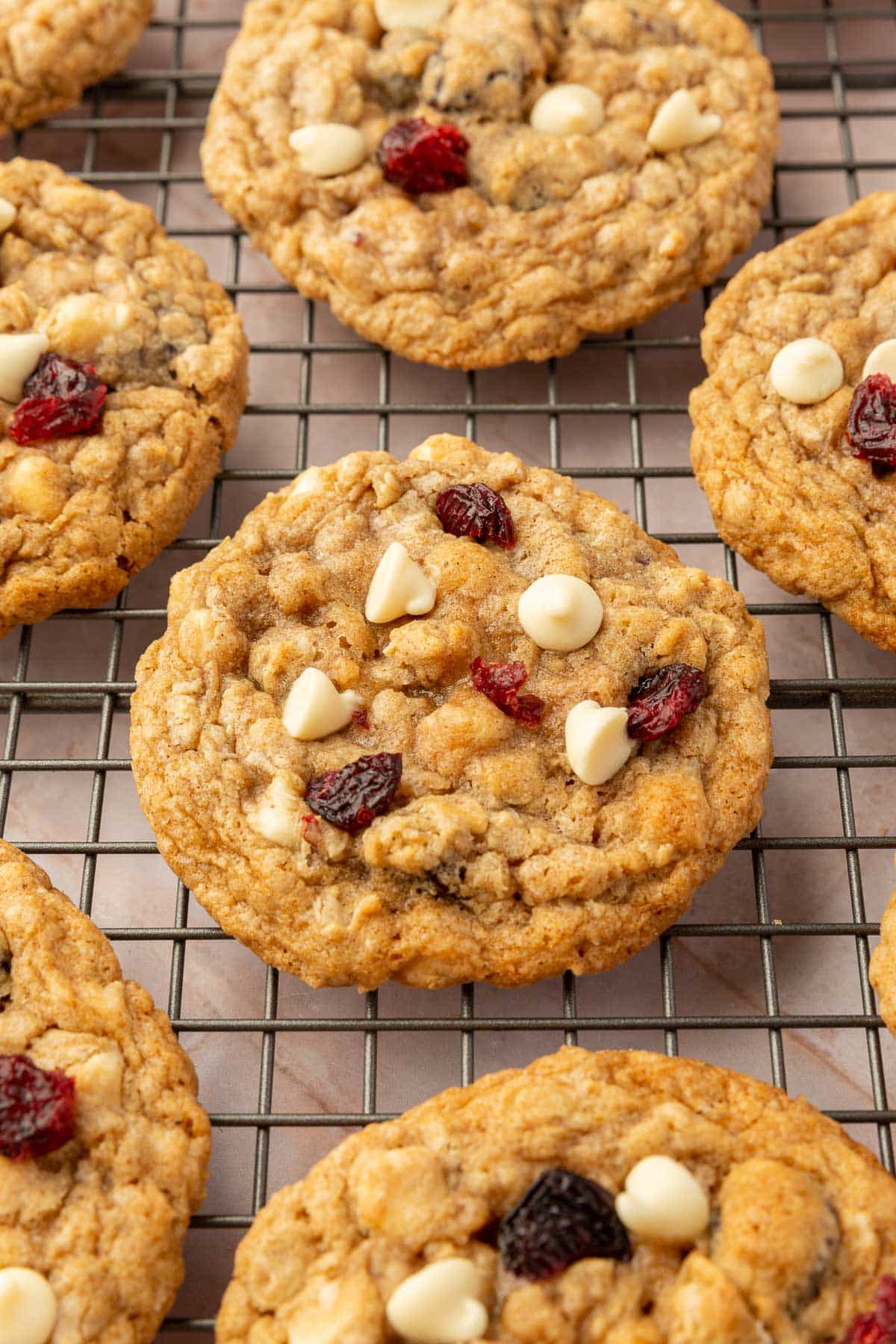Gluten-free cranberry white chocolate oatmeal cookies cooling on a wire rack.