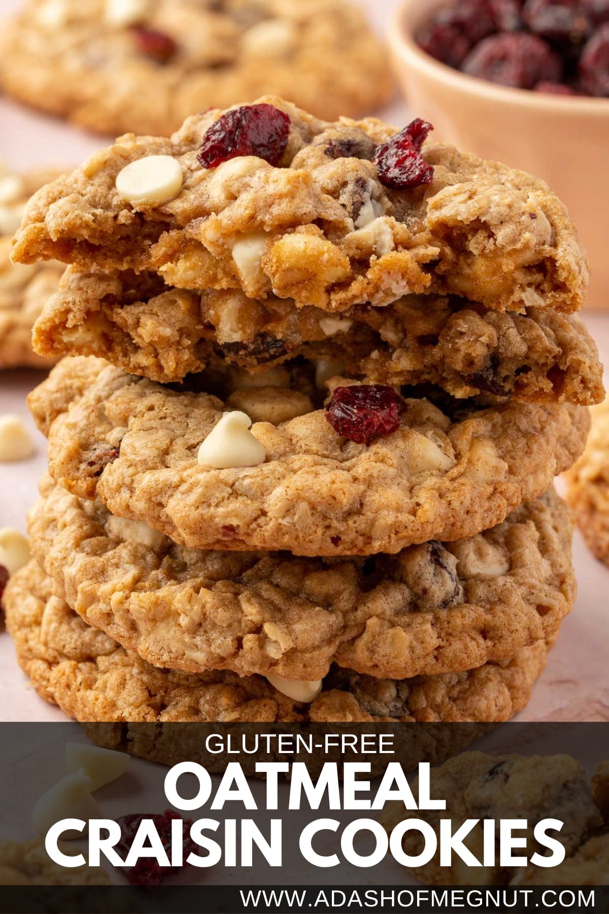 A stack of white chocolate oatmeal craisin cookies with the top two cookies cut in half.