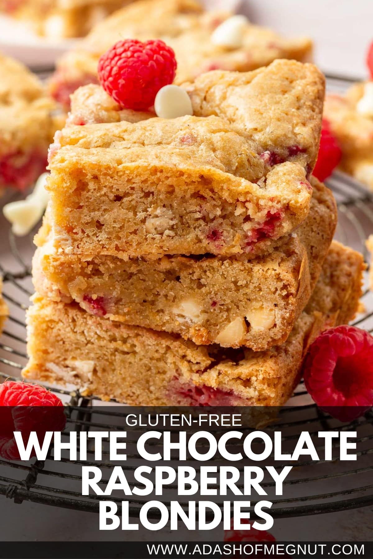 A stack of three white chocolate and raspberry blondies on a cooling rack.
