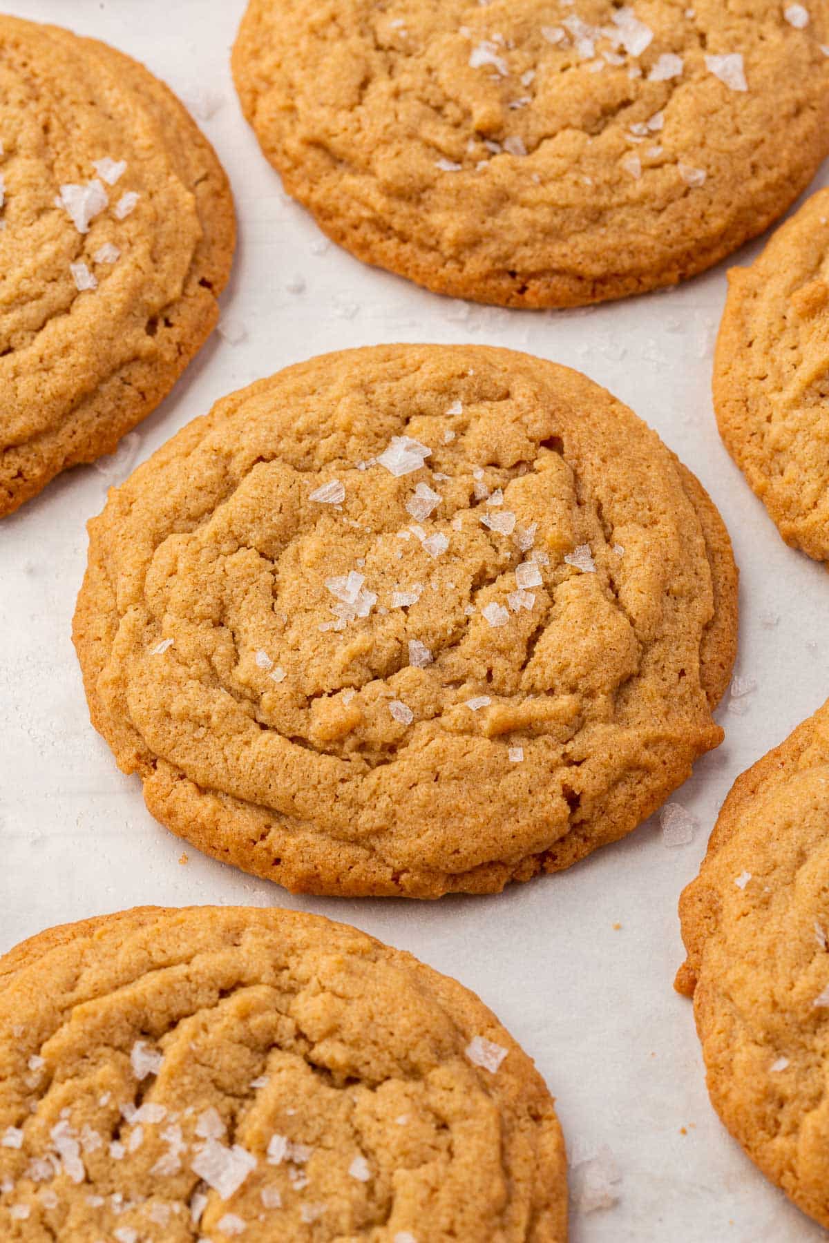 Sx gluten free peanut butter cookies on a piece of parchment paper.