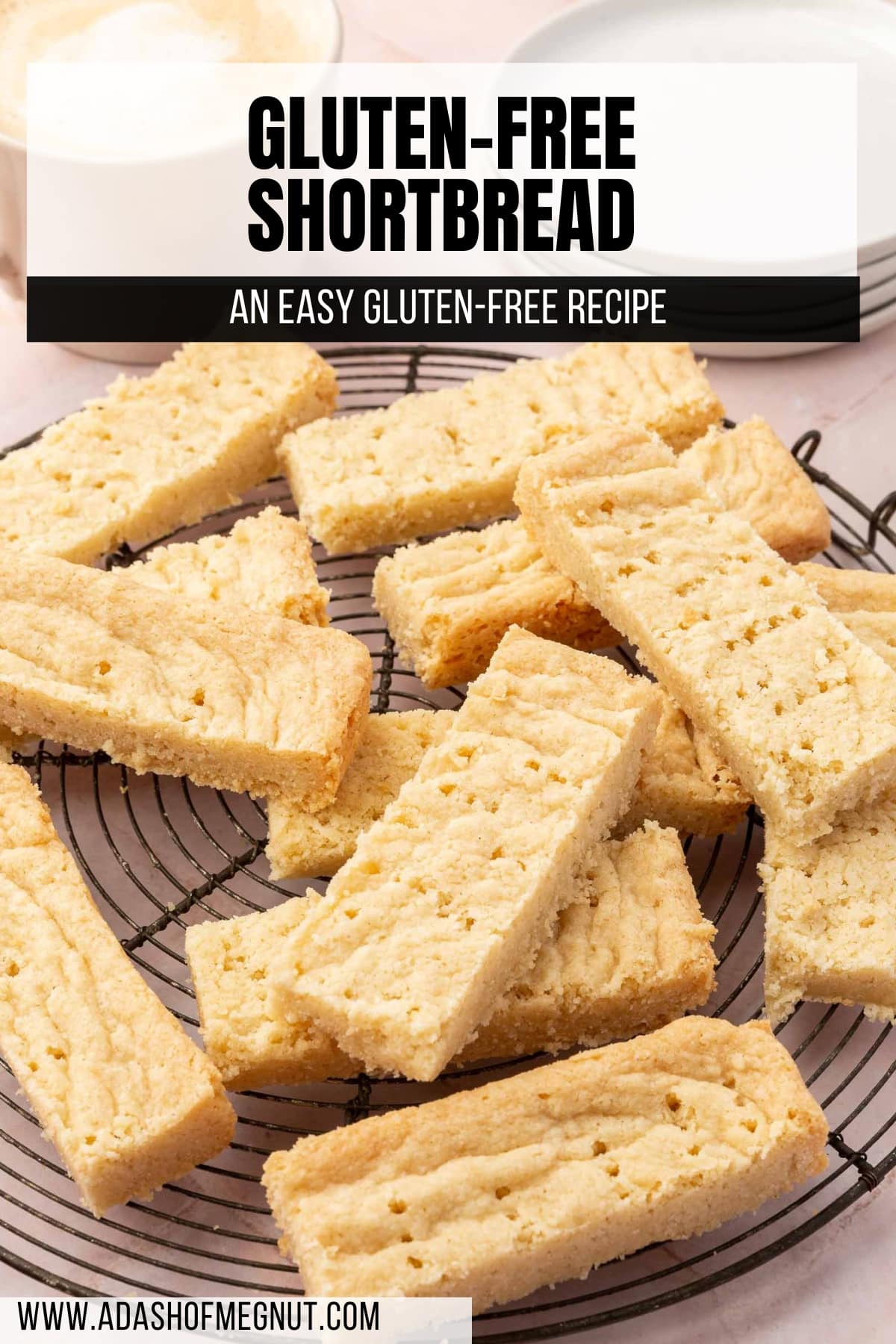 Gluten-free shortbread fingers stacked on top of each other on a round wire cooling rack.