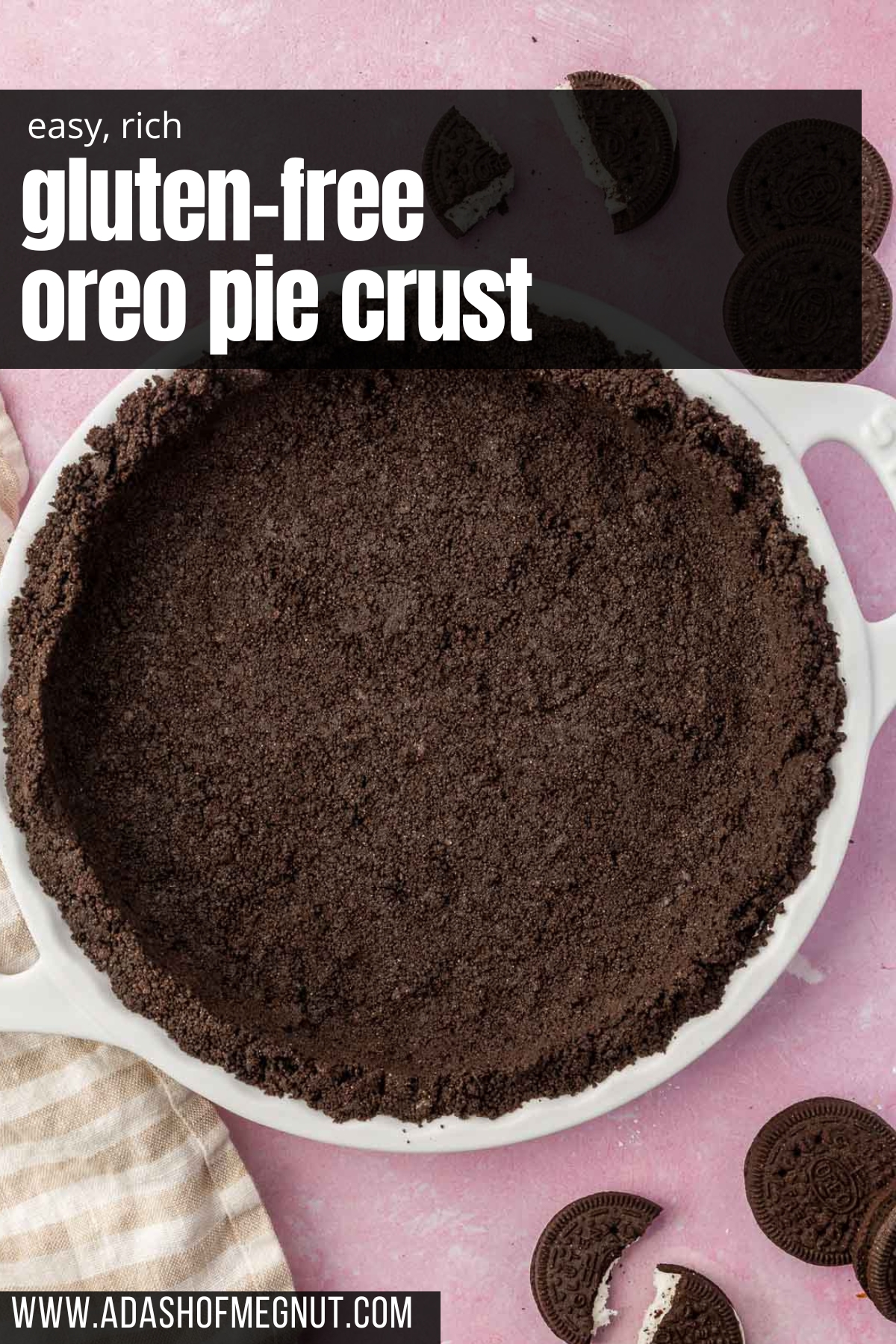 An oreo pie crust pressed into a white tart pan with whole and broken gluten-free Oreos surrounding the pan on the surface.